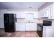 Kitchen featuring black appliances, tile flooring, and plenty of bright, white cabinetry at 746 Oak Terrace Ter, Norcross, GA 30071