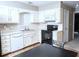 Kitchen featuring tile flooring, white countertops, and neutral backsplash plus an open kitchenette at 746 Oak Terrace Ter, Norcross, GA 30071