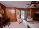 A living room featuring a ceiling fan, wood paneling, and furniture at 746 Oak Terrace Ter, Norcross, GA 30071