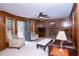 Comfortable living room featuring a brick fireplace, ceiling fan, and hardwood paneling at 746 Oak Terrace Ter, Norcross, GA 30071
