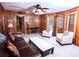 A living room with a ceiling fan, wood paneling, and furniture at 746 Oak Terrace Ter, Norcross, GA 30071