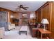 Cozy living room featuring a brick fireplace, wood paneling, and comfortable seating at 746 Oak Terrace Ter, Norcross, GA 30071