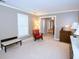 Bright living room featuring neutral walls, a red chair, and carpet floors at 746 Oak Terrace Ter, Norcross, GA 30071
