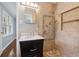 Modern bathroom featuring tiled walls, a walk-in shower with multiple body jets and dark vanity with drawers at 756 Butler Ct, Lawrenceville, GA 30044