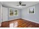 Bright bedroom featuring hardwood floors, and two large double-hung windows offering picturesque views at 756 Butler Ct, Lawrenceville, GA 30044