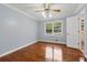 Well-lit bedroom boasts hardwood floors, neutral paint, ceiling fan and a double-hung window creating a serene retreat at 756 Butler Ct, Lawrenceville, GA 30044
