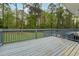 A spacious deck with a gray railing, offering a serene outdoor space overlooking a lush, green backyard at 756 Butler Ct, Lawrenceville, GA 30044