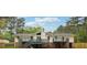 Rear exterior view of home with a large deck and steps leading to the spacious backyard at 756 Butler Ct, Lawrenceville, GA 30044