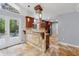 Open concept kitchen featuring stone floors, breakfast bar, stainless steel appliances, and a view to the deck at 756 Butler Ct, Lawrenceville, GA 30044