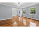 Bright, open-concept living room featuring gleaming hardwood floors and large windows at 756 Butler Ct, Lawrenceville, GA 30044