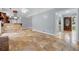 Open-concept living space with stone tile floors leading to a kitchen with a breakfast bar at 756 Butler Ct, Lawrenceville, GA 30044