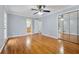 Serene main bedroom featuring hardwood floors, a ceiling fan, ensuite bathroom, and a mirrored closet at 756 Butler Ct, Lawrenceville, GA 30044