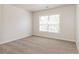A cozy bedroom boasts neutral walls, plush carpeting, and a window offering natural light at 2168 Sugar Maple Nw Cv, Acworth, GA 30101