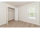 Bedroom featuring neutral walls, plush carpeting, and a walk-in closet offering storage and natural light at 2168 Sugar Maple Nw Cv, Acworth, GA 30101