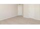 This carpeted bedroom has neutral colors and two white doors at 2168 Sugar Maple Nw Cv, Acworth, GA 30101