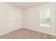 Bedroom featuring neutral walls, plush carpeting, and a large closet with sliding doors at 2168 Sugar Maple Nw Cv, Acworth, GA 30101