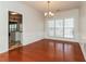 Bright dining room with hardwood floors and a large window providing natural light at 2168 Sugar Maple Nw Cv, Acworth, GA 30101