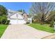 Inviting two-story home featuring a long driveway and lush green lawn at 2168 Sugar Maple Nw Cv, Acworth, GA 30101