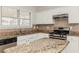 Well-equipped kitchen with granite countertops, white cabinetry, and stainless steel appliances at 2168 Sugar Maple Nw Cv, Acworth, GA 30101