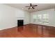 A living room with hardwood floors, a fireplace, and ample natural light at 2168 Sugar Maple Nw Cv, Acworth, GA 30101