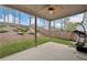 Covered patio with ceiling fan offers outdoor lounge space overlooking backyard at 234 Fieldbrook Xing, Canton, GA 30115
