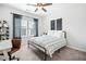 A cozy bedroom showcasing a metal bed frame, ceiling fan and a window with natural light at 234 Fieldbrook Xing, Canton, GA 30115
