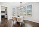Charming breakfast nook featuring a marble table, modern light fixture, and adjacent butler's pantry at 234 Fieldbrook Xing, Canton, GA 30115