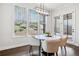 Bright breakfast nook features a marble table, modern light fixture, and views of the landscaped yard at 234 Fieldbrook Xing, Canton, GA 30115