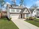 Charming two-story home featuring a two-car garage, well-manicured lawn, and inviting curb appeal at 234 Fieldbrook Xing, Canton, GA 30115