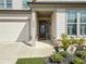 Close-up of the front door and a partial view of the garage, highlighting the home's exterior details at 234 Fieldbrook Xing, Canton, GA 30115