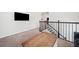 Upstairs hallway featuring hardwood stairs, iron railing and TV on wall at 234 Fieldbrook Xing, Canton, GA 30115
