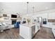 Open-concept living space with kitchen island, stainless appliances, and cozy living room at 234 Fieldbrook Xing, Canton, GA 30115