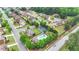 Aerial view of a residential neighborhood showcasing homes, green spaces, and a community pool at 2369 Apalachee Crucis Ln, Dacula, GA 30019