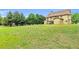 A large, lush backyard with plenty of green space and mature trees offers ample room to play and relax at 2369 Apalachee Crucis Ln, Dacula, GA 30019