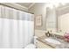 Bathroom with a white shower curtain, wainscoting, and granite countertops at 2369 Apalachee Crucis Ln, Dacula, GA 30019