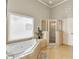 This bathroom boasts a soaking tub and a separate walk-in shower at 2369 Apalachee Crucis Ln, Dacula, GA 30019