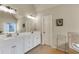 Bright bathroom featuring a large vanity with double sinks and tiled floors at 2369 Apalachee Crucis Ln, Dacula, GA 30019