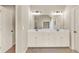 Double sink vanity with cabinets and a large mirror provide a practical bathroom at 2369 Apalachee Crucis Ln, Dacula, GA 30019