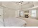 This is a beautiful bedroom with a fireplace and a tray ceiling with fan at 2369 Apalachee Crucis Ln, Dacula, GA 30019