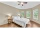 Bright bedroom features hardwood floors, large windows, and a ceiling fan at 2369 Apalachee Crucis Ln, Dacula, GA 30019