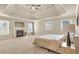 Spacious bedroom features a tray ceiling, fireplace, and plenty of natural light at 2369 Apalachee Crucis Ln, Dacula, GA 30019