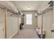Walk-in closet with a carpet floor and shelving for organizing your wardrobe at 2369 Apalachee Crucis Ln, Dacula, GA 30019