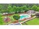 A well-maintained community pool area featuring a pool, playground, and green spaces for recreation and leisure at 2369 Apalachee Crucis Ln, Dacula, GA 30019