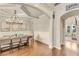 Sophisticated dining room featuring wainscoting, a modern chandelier, and hardwood flooring at 2369 Apalachee Crucis Ln, Dacula, GA 30019