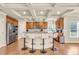 Kitchen with a tile backsplash, wooden cabinetry, and an island with bar stool seating at 2369 Apalachee Crucis Ln, Dacula, GA 30019