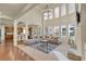 Open concept living room with a fireplace and a view into the kitchen at 2369 Apalachee Crucis Ln, Dacula, GA 30019