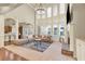 Spacious living room with a fireplace, a chandelier, and many windows at 2369 Apalachee Crucis Ln, Dacula, GA 30019
