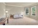 Bright living room with neutral walls, carpet, and two large windows providing ample natural light at 2369 Apalachee Crucis Ln, Dacula, GA 30019