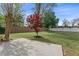 Concrete patio area with a tree in the yard and a wood fence surrounding the property at 2500 Grand Manor Ct, Marietta, GA 30068