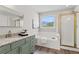 Bright bathroom with a soaking tub, walk-in shower, and granite-topped vanity with gold accents at 2500 Grand Manor Ct, Marietta, GA 30068
